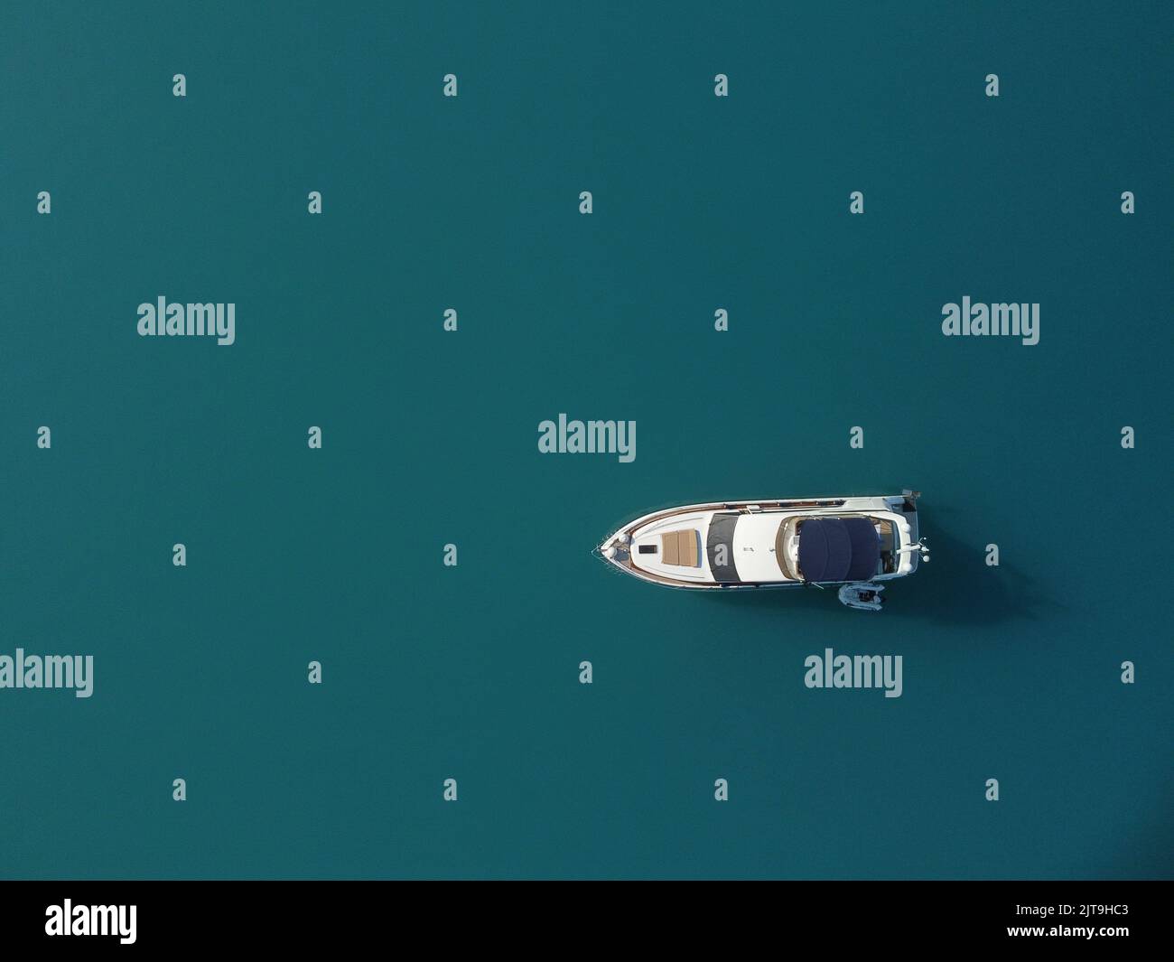 Aerial yacht on calm sea. Luxury cruise trip. View from above of white ...