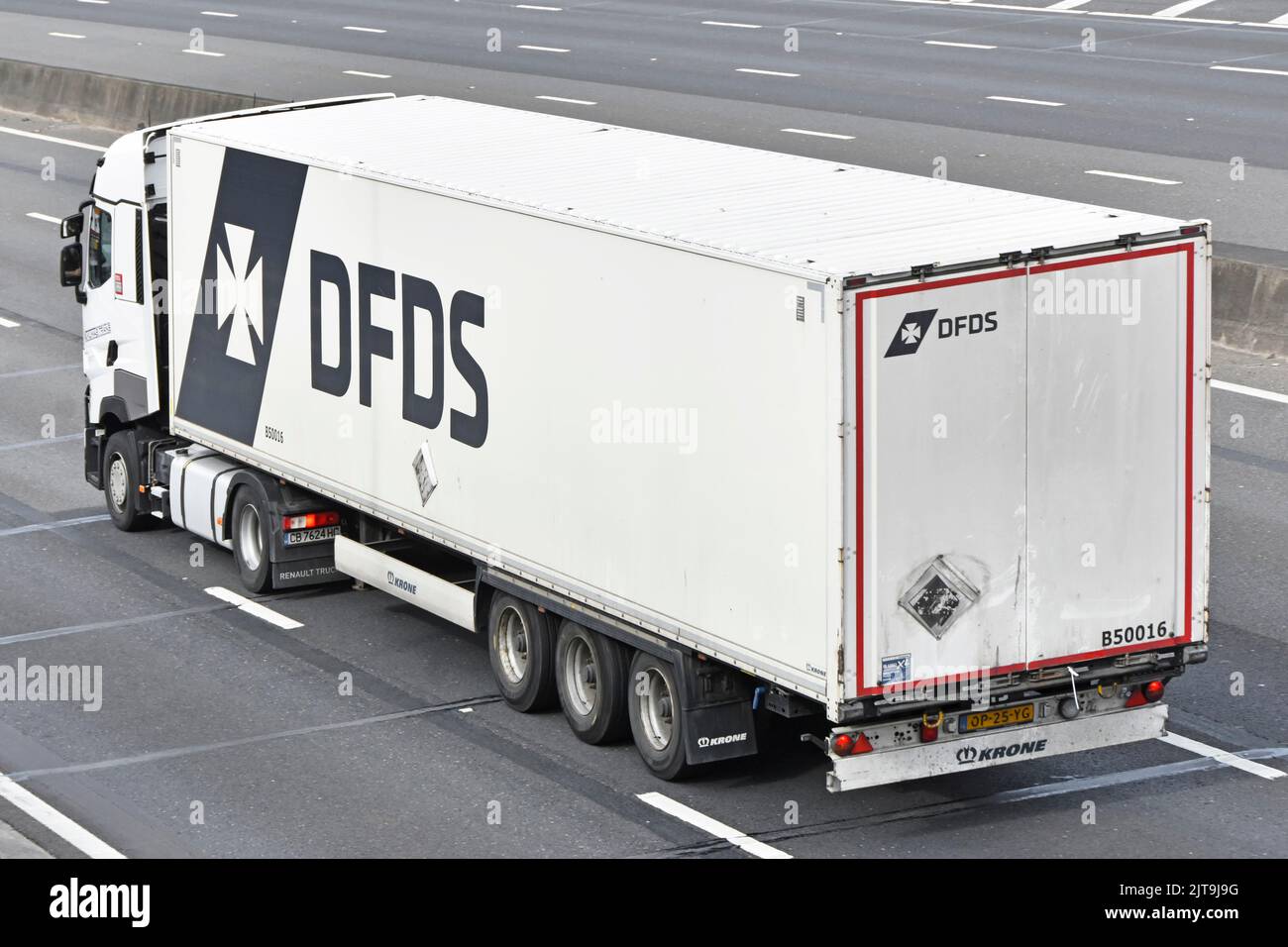 Side back and aerial view of white DFDS logo Danish international shipping logistics business hgv lorry truck articulated trailer driving UK motorway Stock Photo