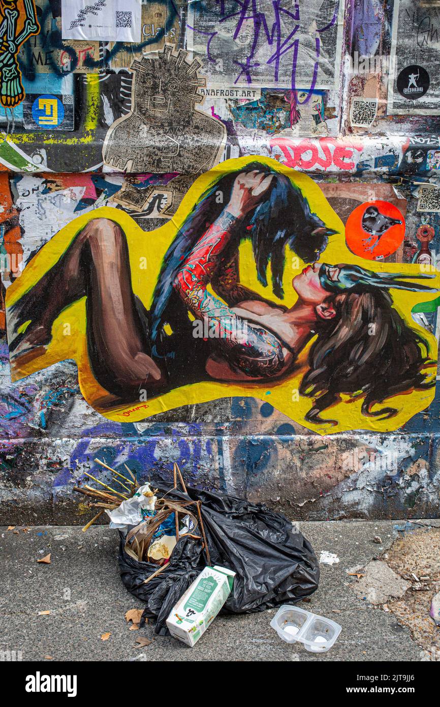Black bin bag with garbage in front of  urban street art in Briklane , London , England. Stock Photo