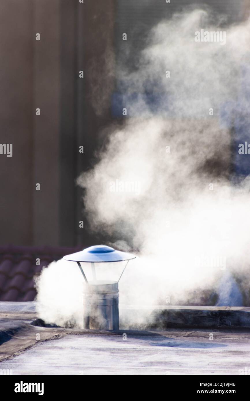 Stainless steel chimney, expelling smoke or steam, in a tourist area