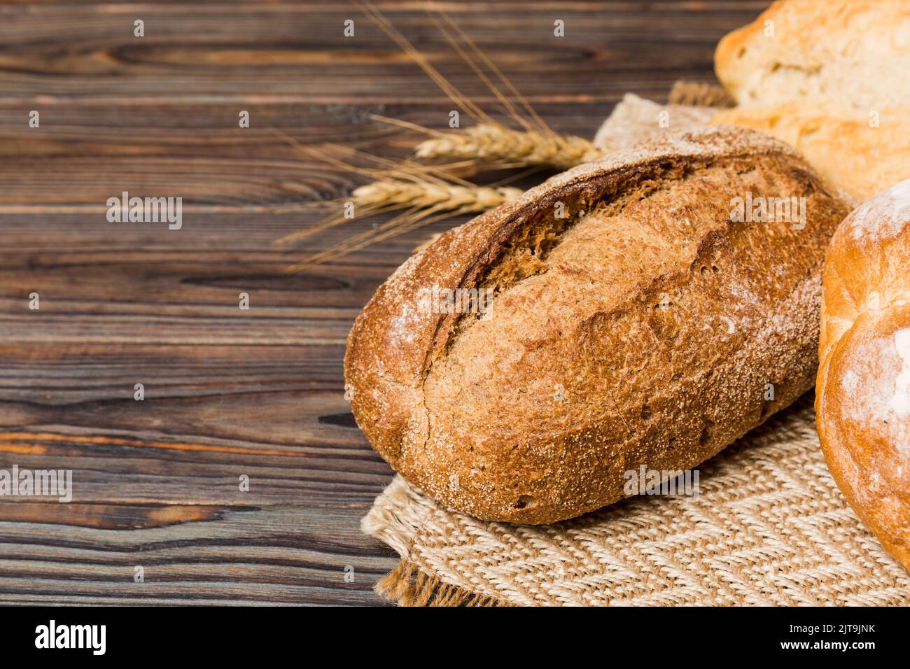 Homemade natural breads. Different kinds of fresh bread as background, perspective view with