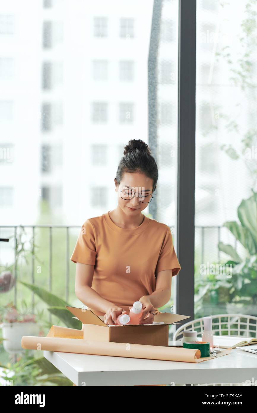 A woman running a small online startup business. Stock Photo