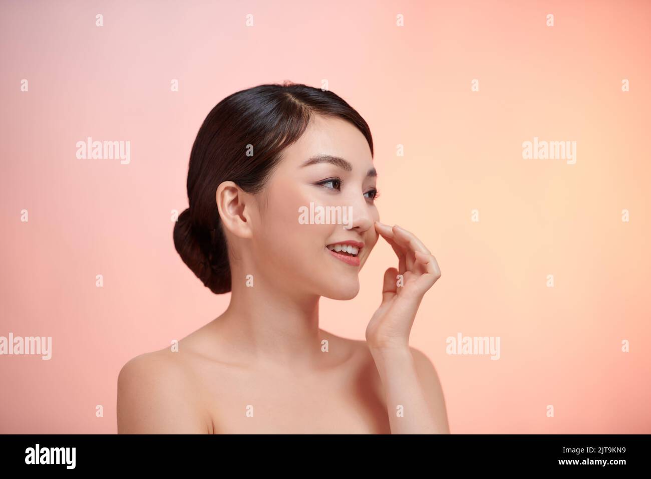 Happy beautiful young Asian woman with clean fresh skin Stock Photo