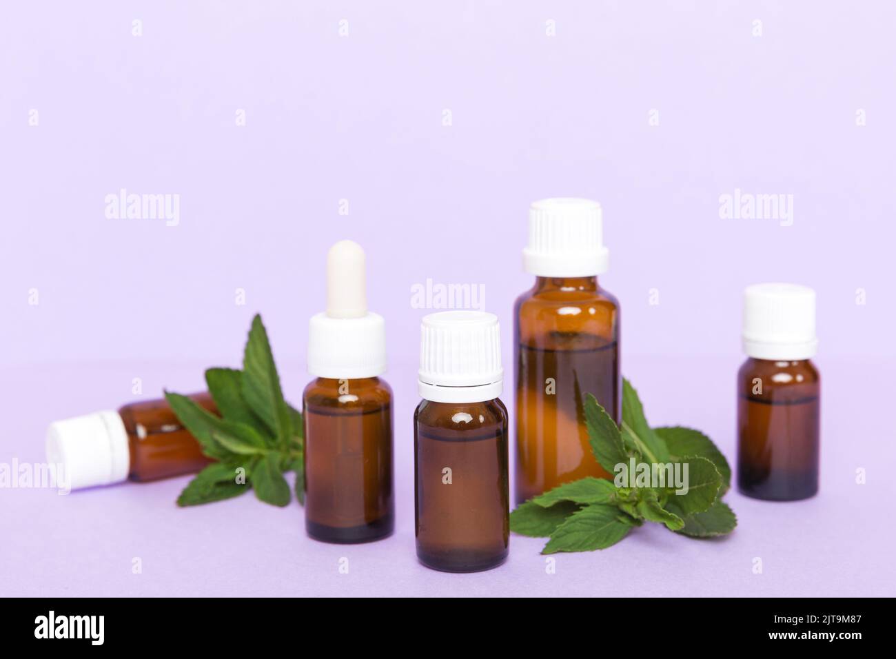 Natural Mint Essential Oil in a Glass Bottle. organic cosmetics with