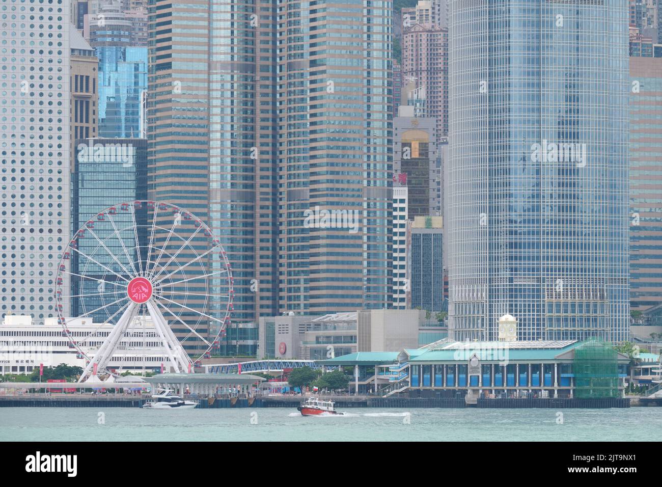 The Ferris wheel in Central, Hong Kong with commercial buildings Stock Photo
