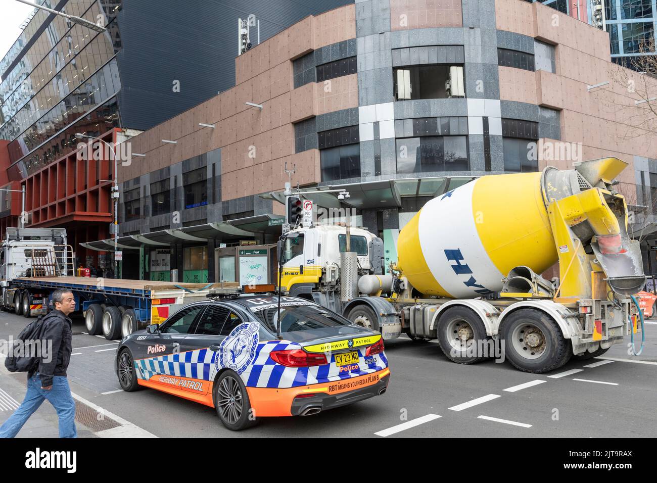 Police car and ready mix concrete truck on Bathurst street in Sydney city centre,NSW,Australia Stock Photo