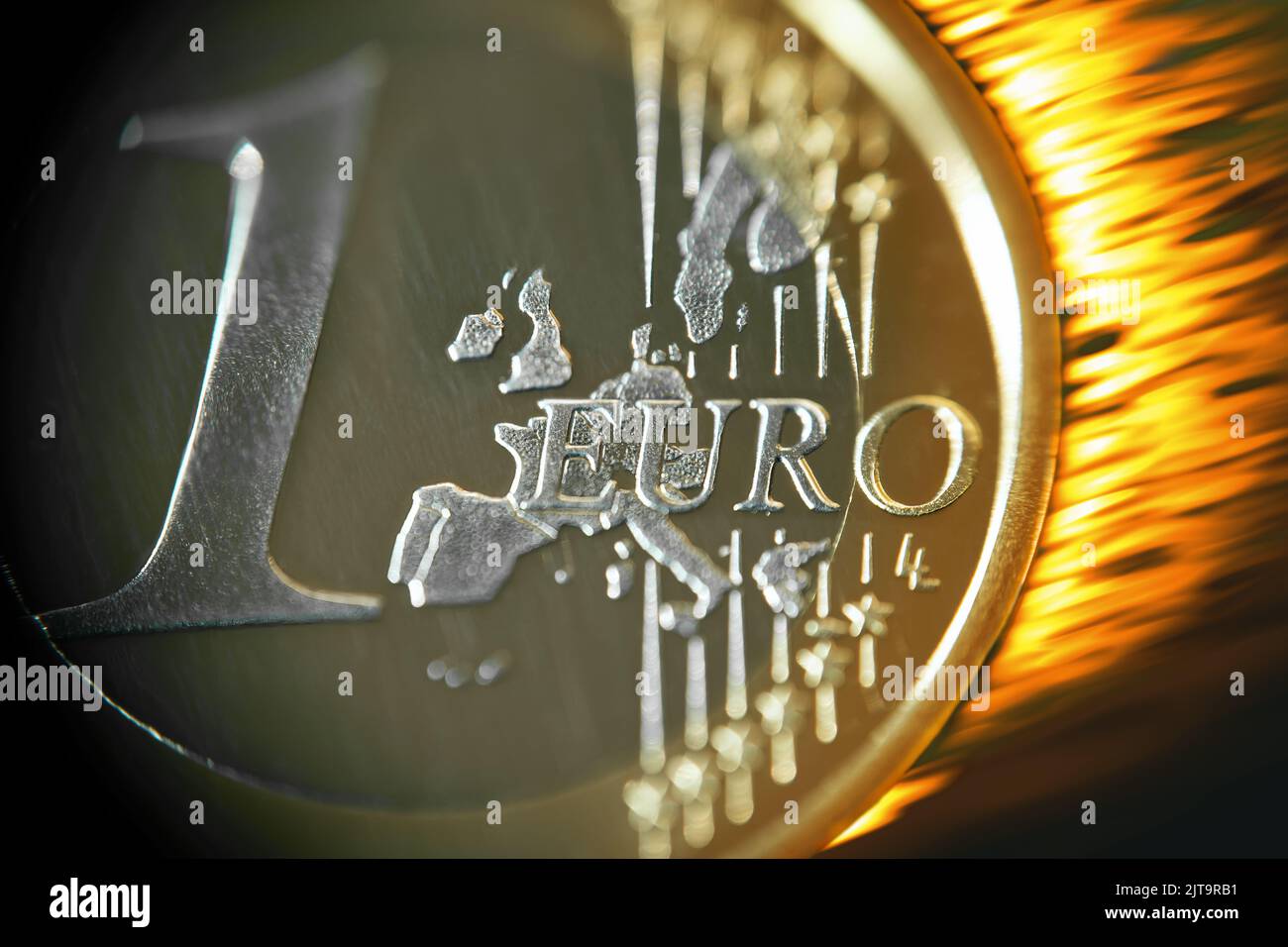 One euro coin, burning fiery, close up. Stock Photo