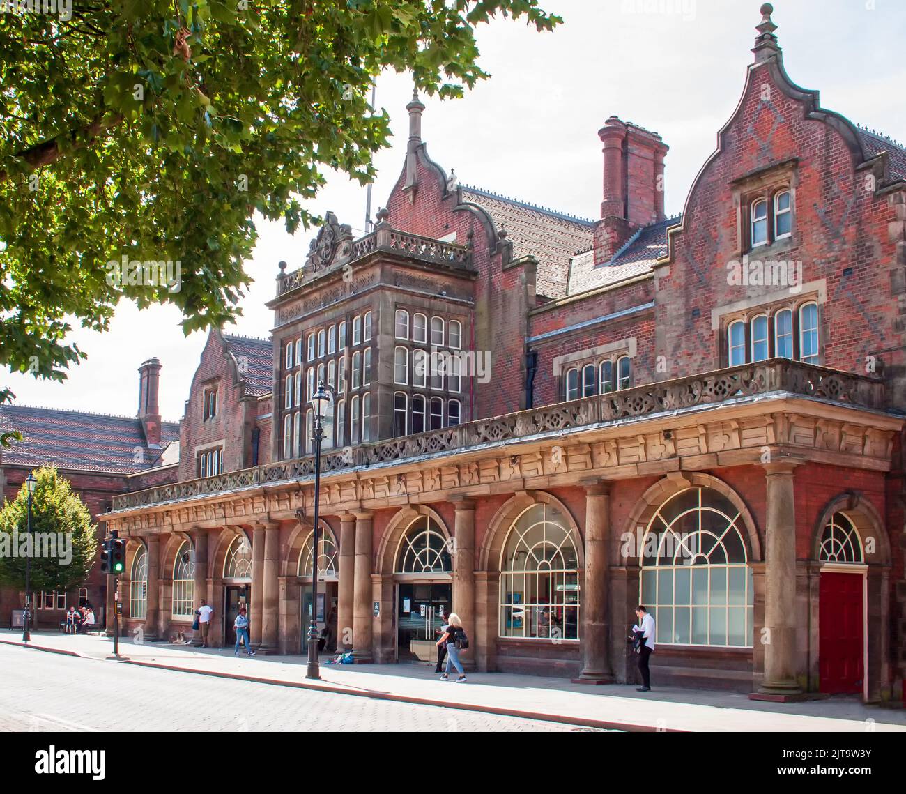 The impressive frontage of the historic railway station at Stoke-on-Trent, with people in close proximity. Stock Photo