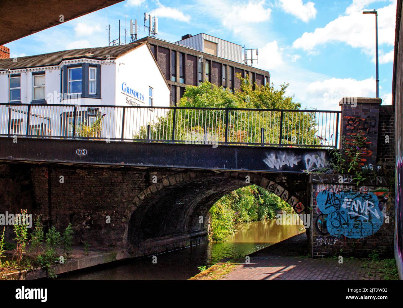 Urban architecture viewed from a sloping canal bridge, carrying the road over the Trent and Mersey Canal, o the junction with the Newcastle Canal Stock Photo