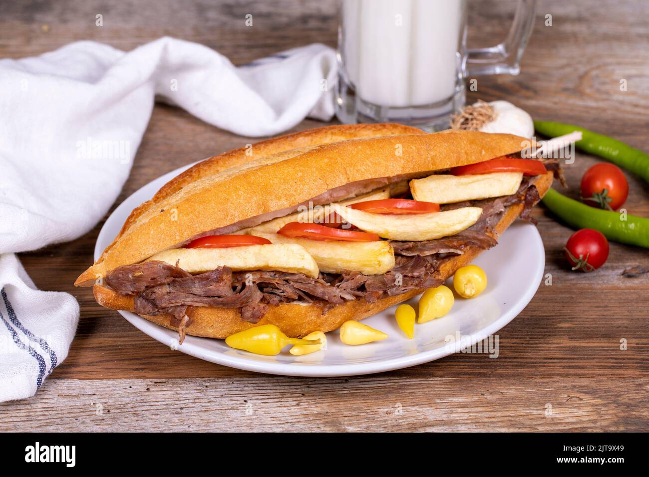 Doner kebab between bread. Meat doner kebab on wooden background