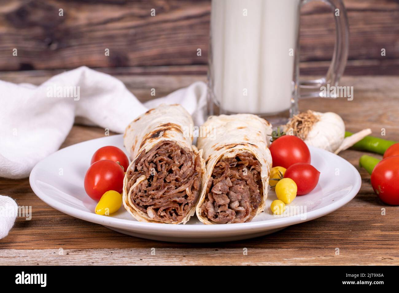 Wrap Doner Kebab. Meat doner kebab on wooden background. Traditional Turkish cuisine. Close-up. local name durum et doner Stock Photo