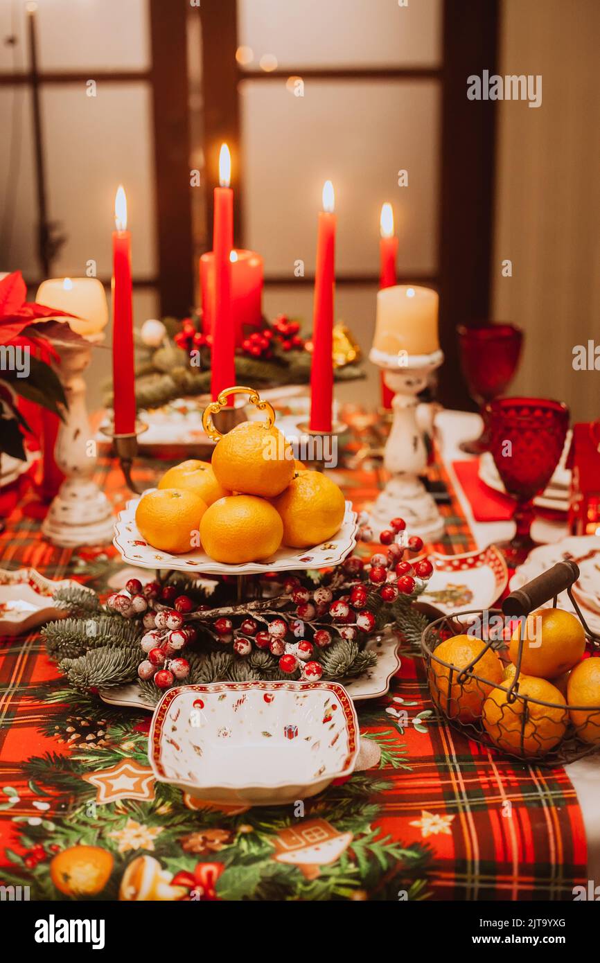 Christmas serving at home with tangerines, fruits, berries. Waiting for