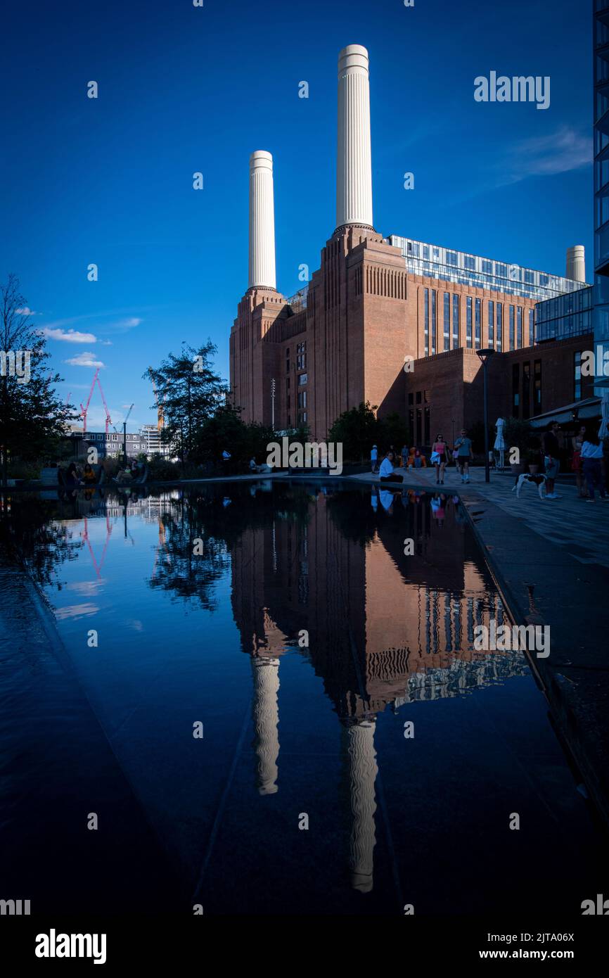 Reflections of Battersea Power Station in brilliant sunshine in the summer Stock Photo