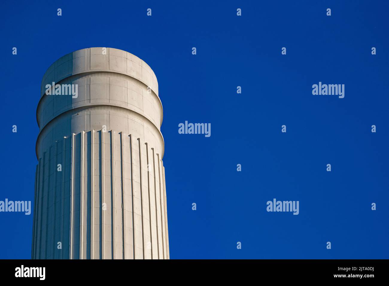 A close up of the chimneys at Battersea Power Station in brilliant sunshine in the summer Stock Photo