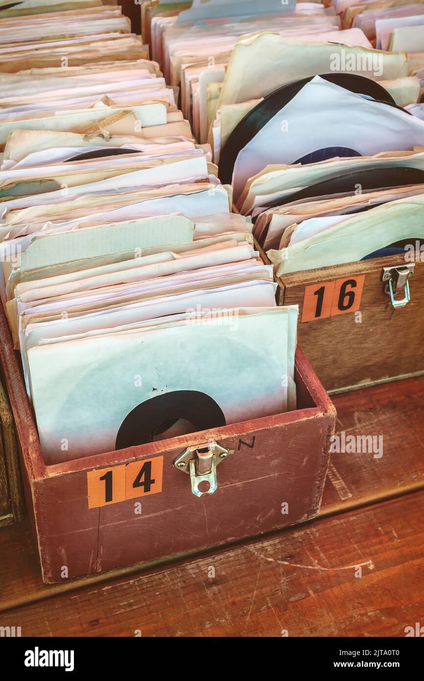 Retro styled image of boxes with vinyl turntable records on a flee market Stock Photo