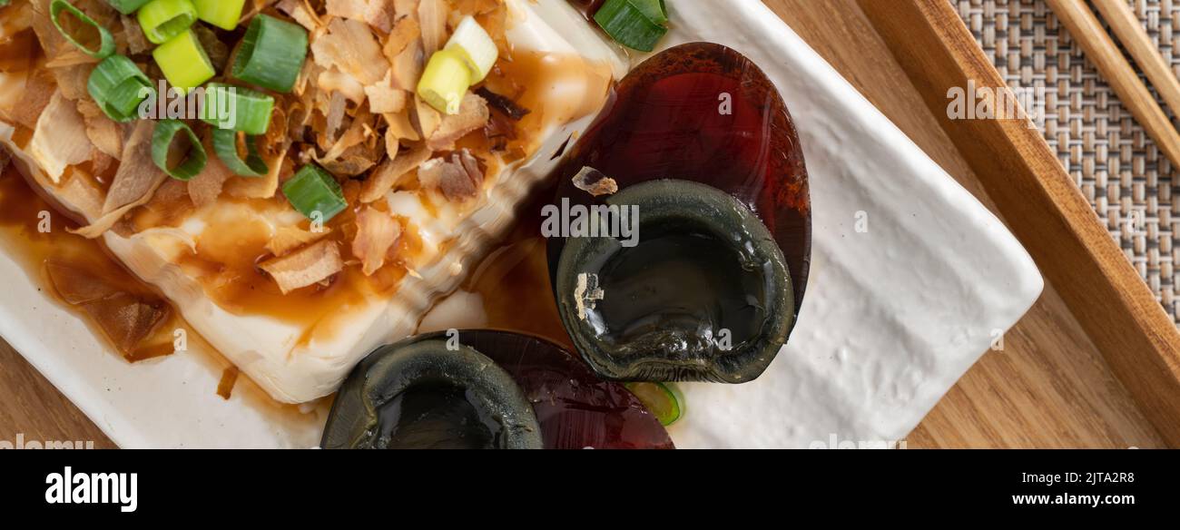 Delicious Chilled tofu and century egg food with soy sauce and bonito