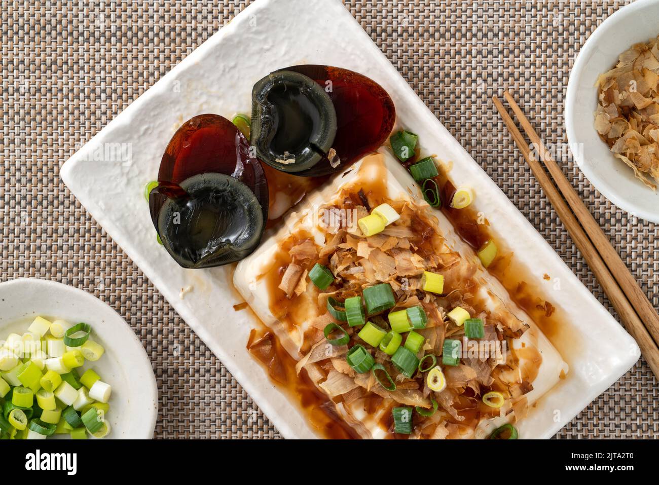 Delicious Chilled tofu and century egg food with soy sauce and bonito