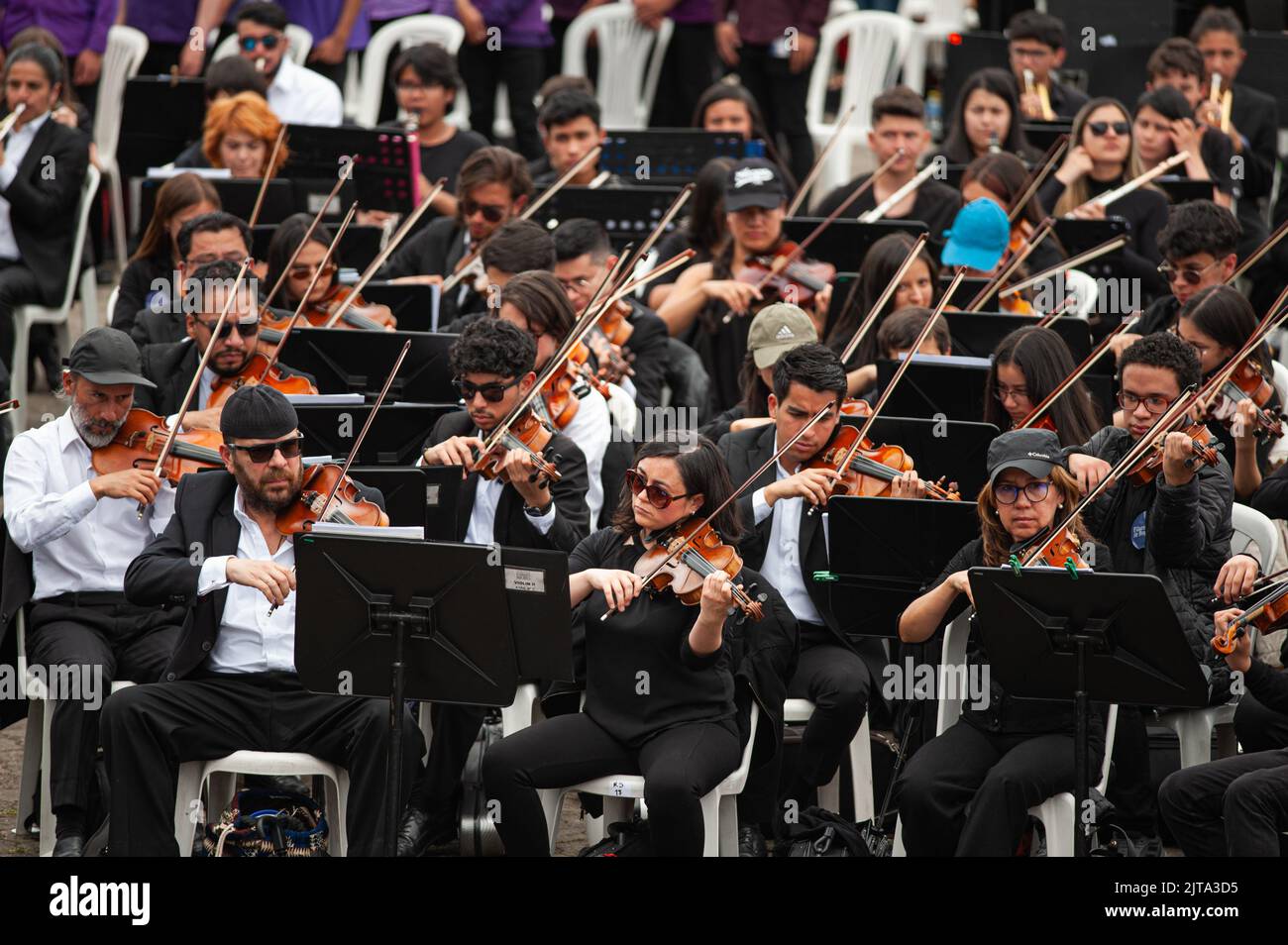 Bogota's Philharmonic Orchestra Violin players during the world's largest concert for peace played by Bogota's Symphonic Orchrestra and children, in B Stock Photo