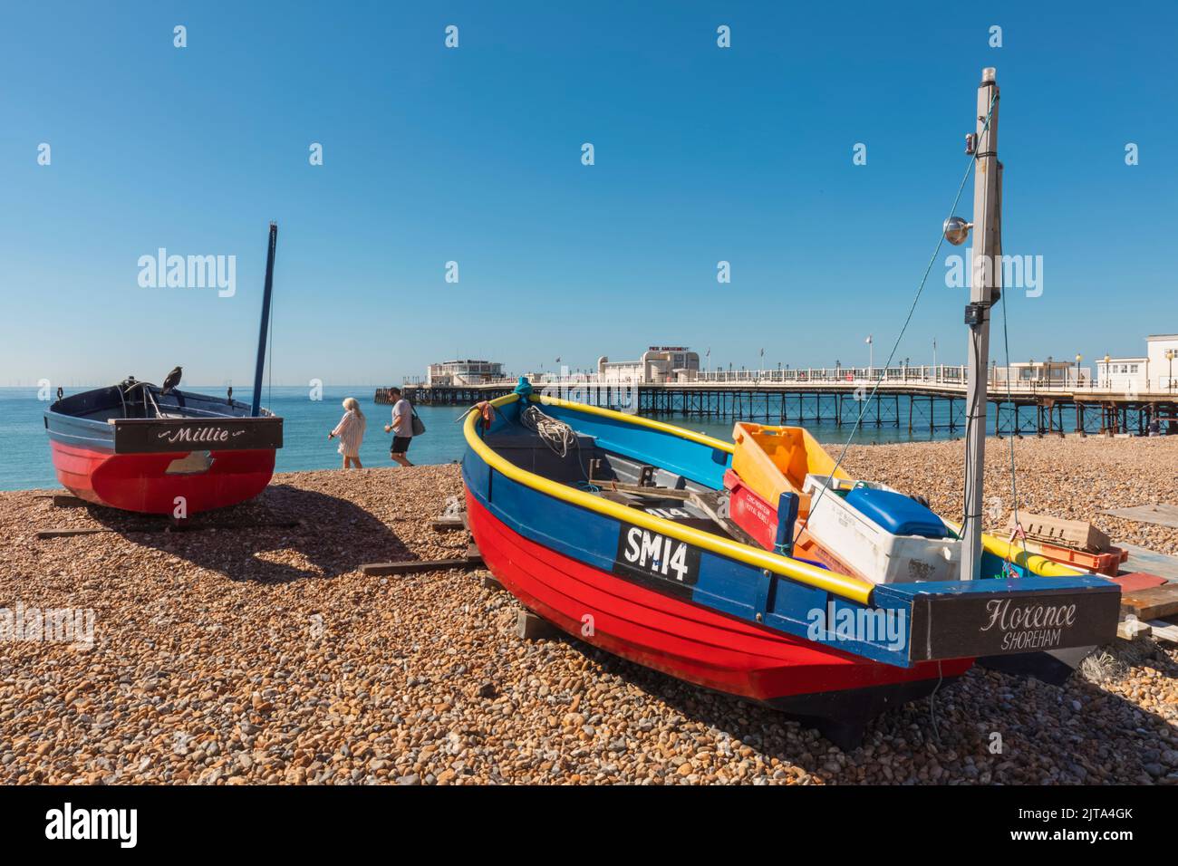 England, West Sussex, Worthing, Worthing Beach, Colourful Fishing Boats and Worthing Pier Stock Photo