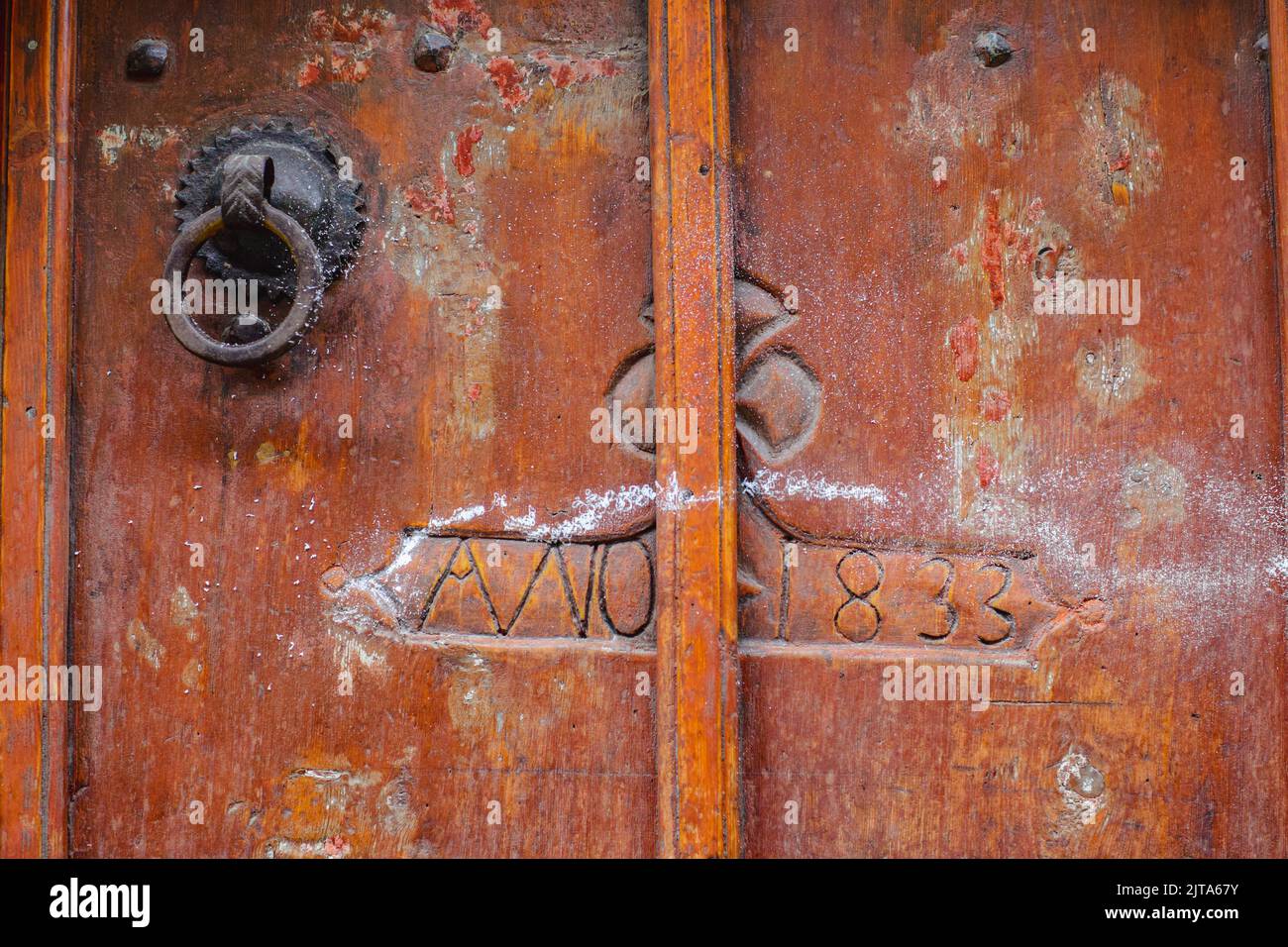 Old door from 1833. Medieval village of Ainsa, one of Spain´s most beautiful locations, Huesca Stock Photo