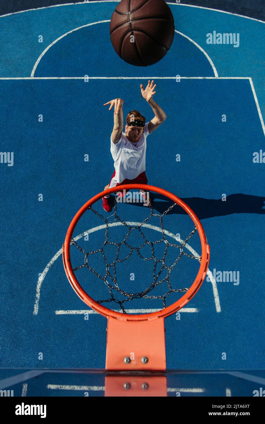 top view of man throwing ball into basketball hoop Stock Photo Alamy