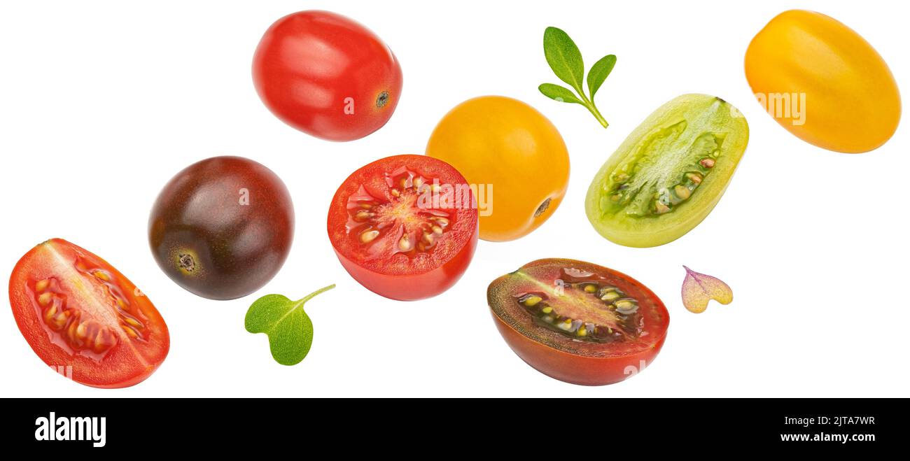 Falling colorful cherry tomatoes isolated on white background Stock Photo