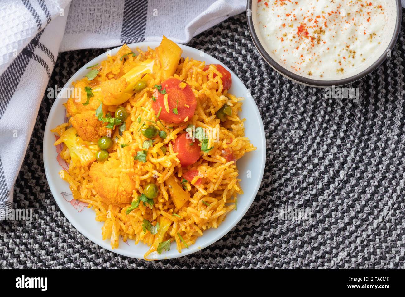 Indian vegetarian fried rice in the plate with carrot, spring onion