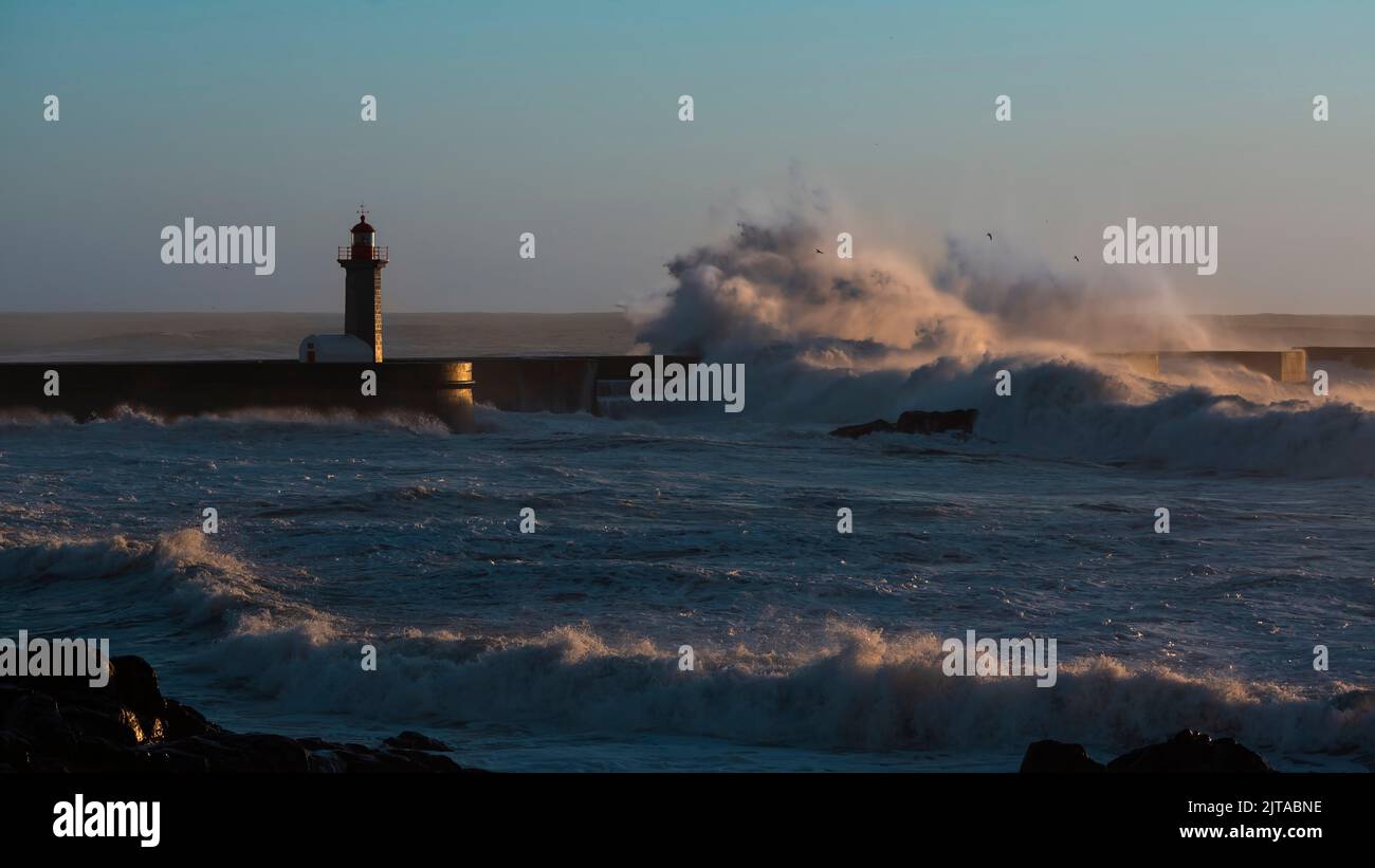 View of the Lighthouse with huge wave at Atlantic ocean in Porto, Portugal. Stock Photo
