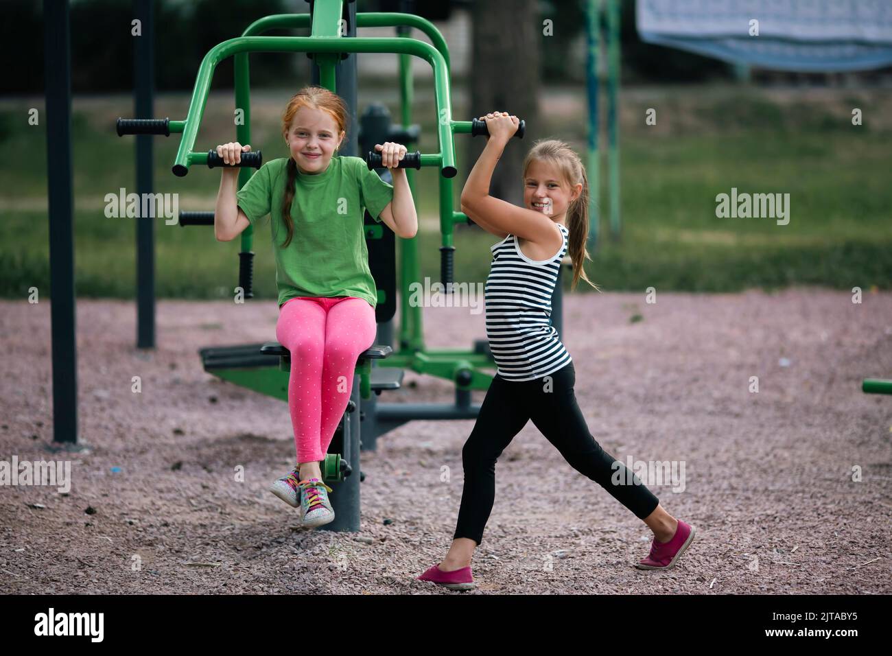 Two cute teengirl friends on sports street trainers. Stock Photo