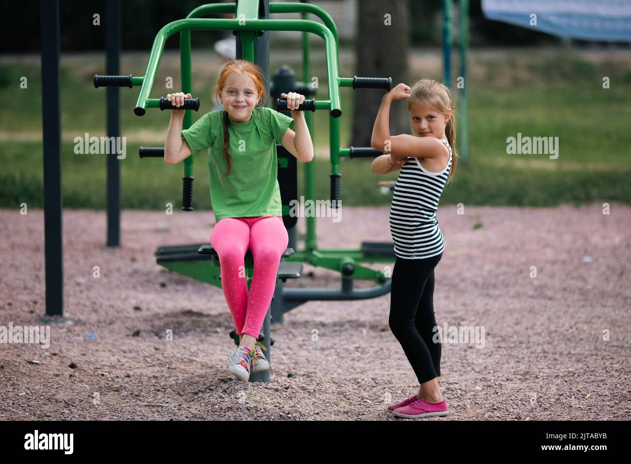 Two cute girls friends on sports street trainers. Stock Photo
