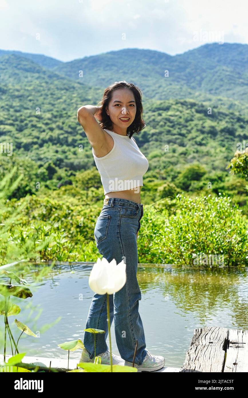 Young Vietnamese woman going for a stroll in a park Stock Photo