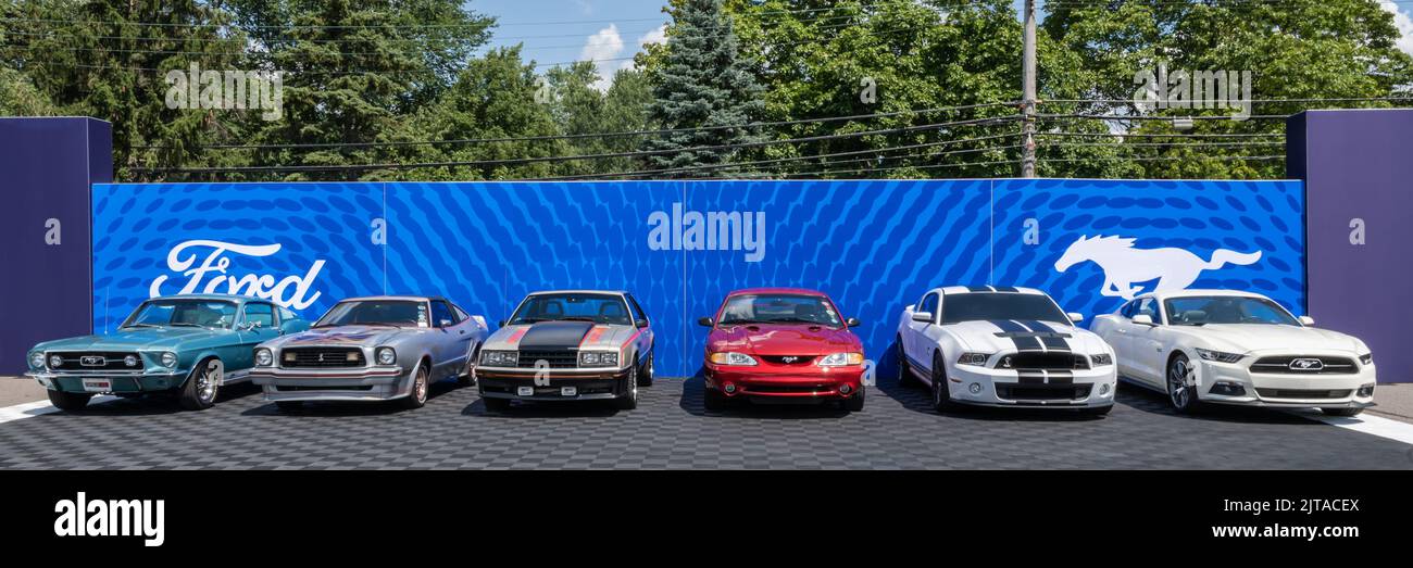 ROYAL OAK, MI/USA - AUGUST 19, 2022: Six generations of Ford Mustang cars, including a GTA, II, Indy Pace Car, and Shelby Cobra, at the Ford exhibit o Stock Photo