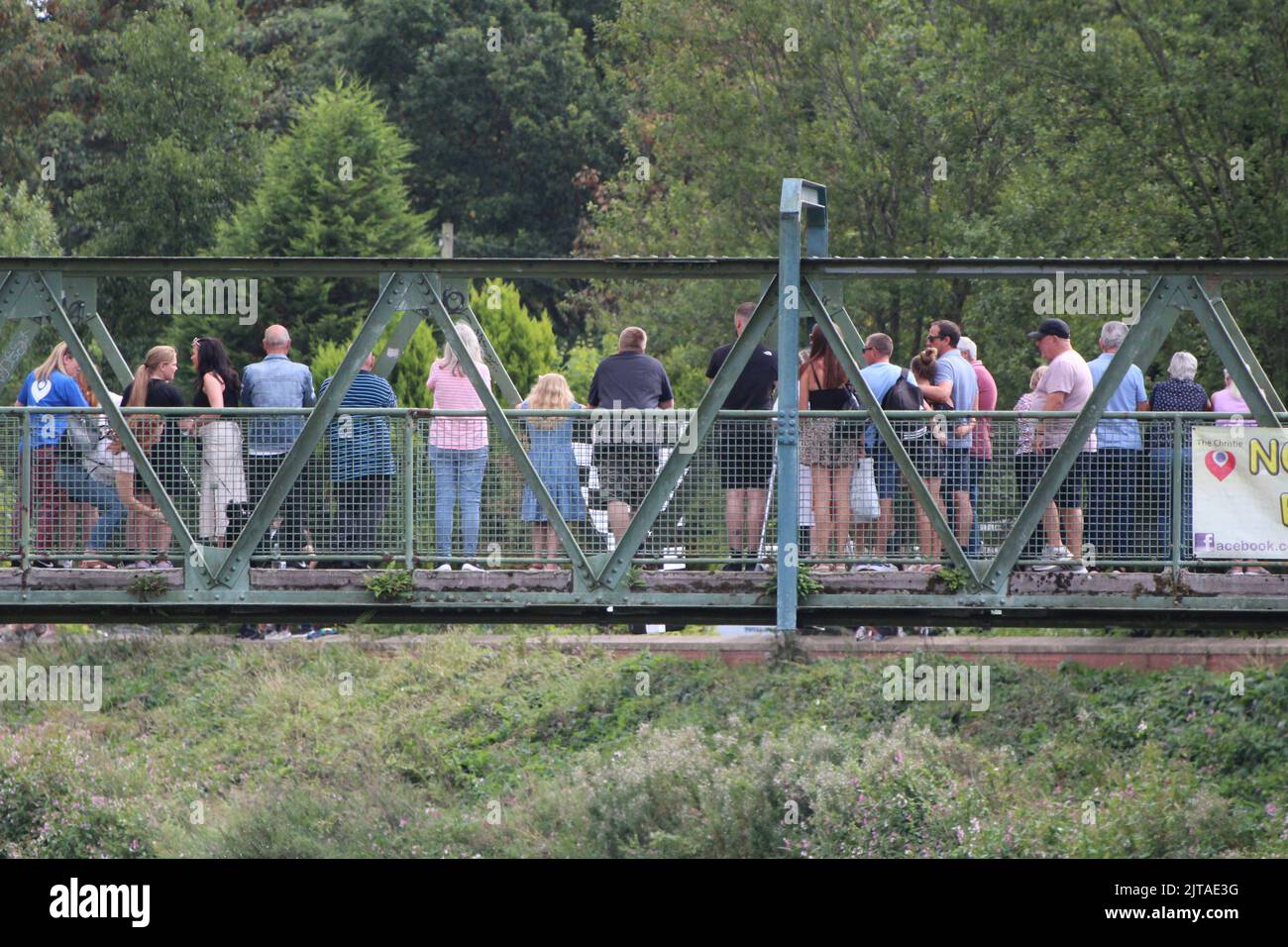People watching the Northenden Boat Race from a bridge. Stock Photo