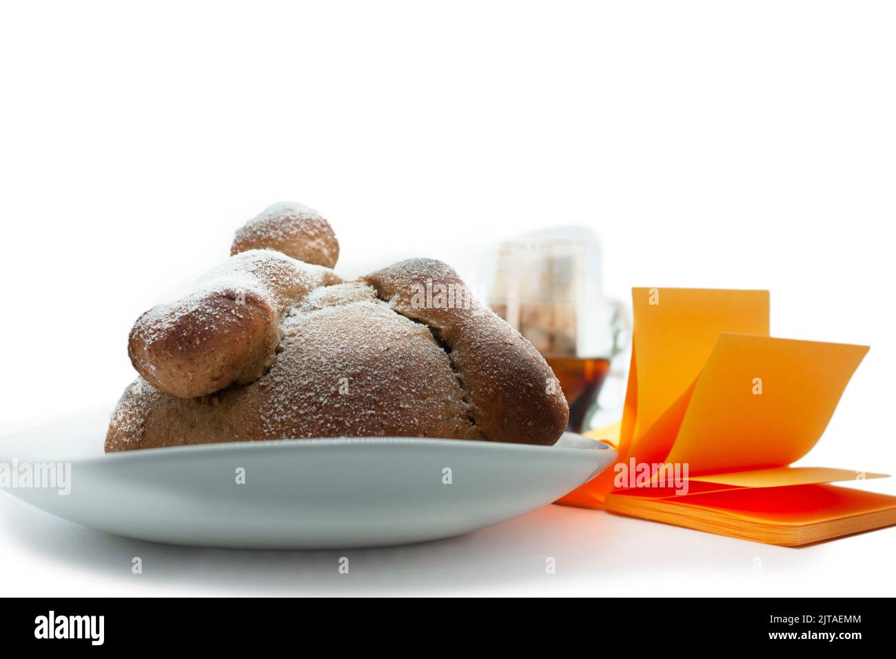 traditional bread for special food to deceased  decorated with simulated bones and sugar next to a coffee and orange paper accompanies the folklore of Stock Photo