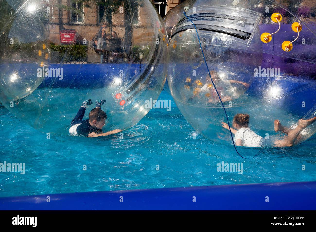Children inside Water ball games at fun fair, Helensburgh, Scotland Stock Photo