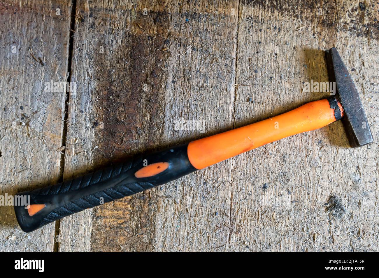 small iron hammer with a long plastic handle for neat precise work