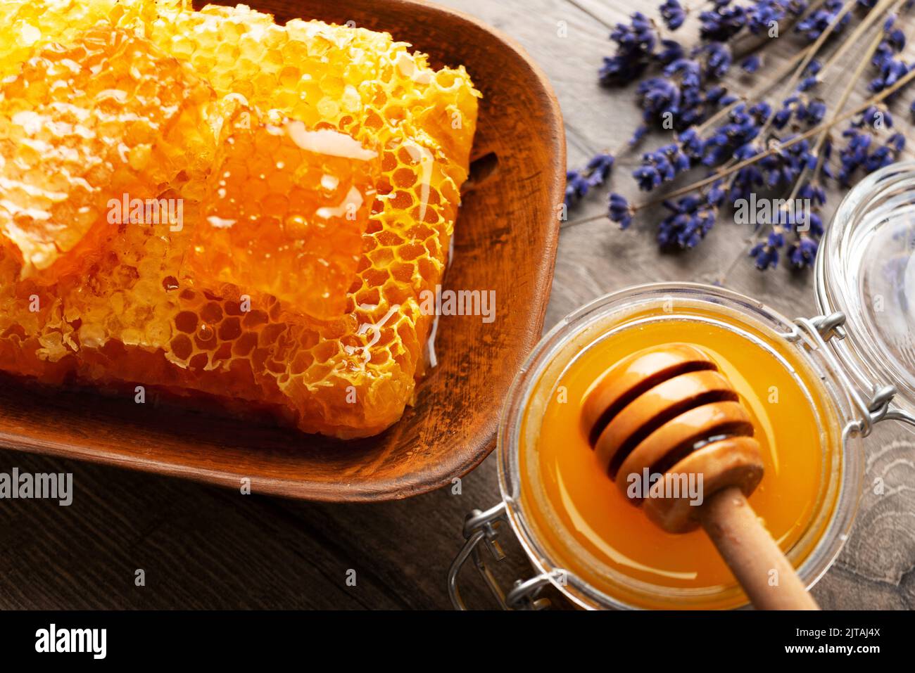 Honeycomb in clay dish on kitchen table sweet background Stock Photo