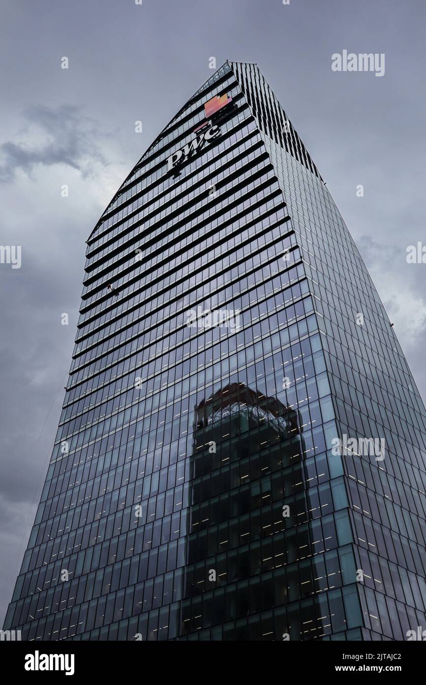 Milan, Italy - June 26, 2022: Vertical Architecture of PWC Office in Lombardy. Glass Building in Tre Torri with Cloudy Sky. Stock Photo
