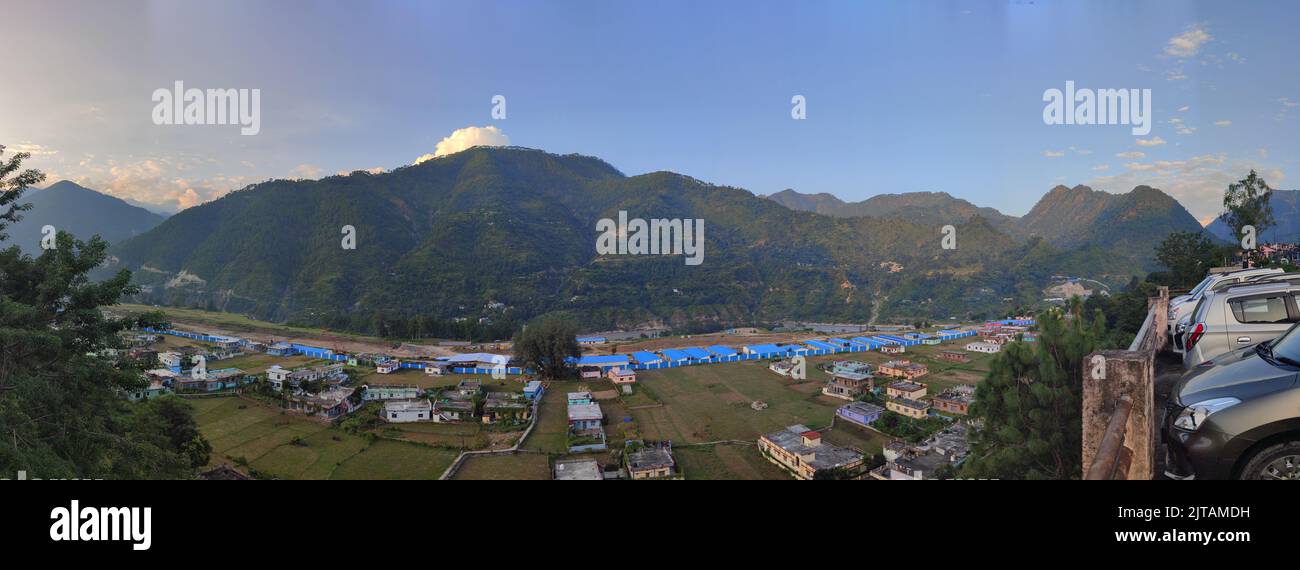 A panoramic view of a village and mountains in the background Stock ...
