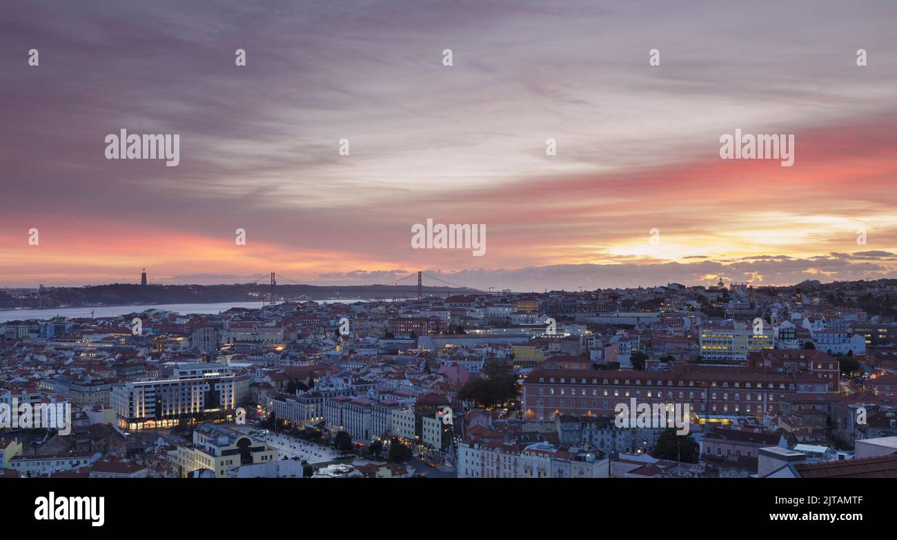 View over downtown with the Christ statue and the 25 de Abril bridge at night, Lisbon, Portugal Stock Photo