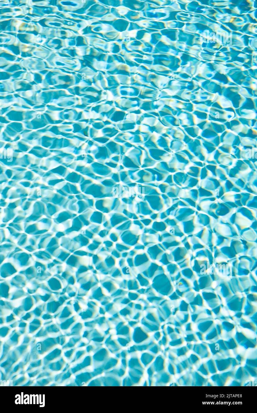 turquoise color background of swimming pool water with ripples. concept