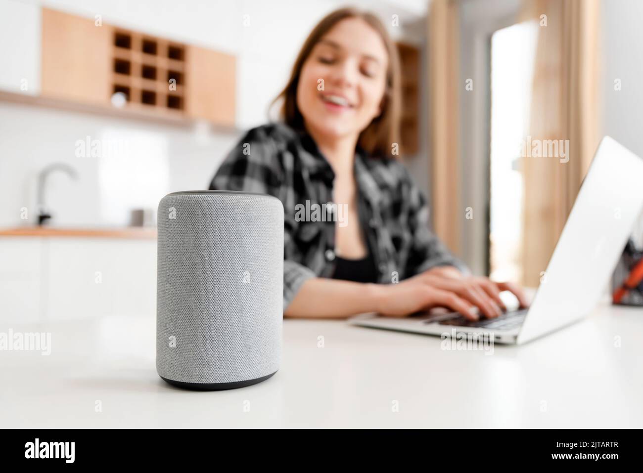 Woman using smart speaker, smart home concept Stock Photo
