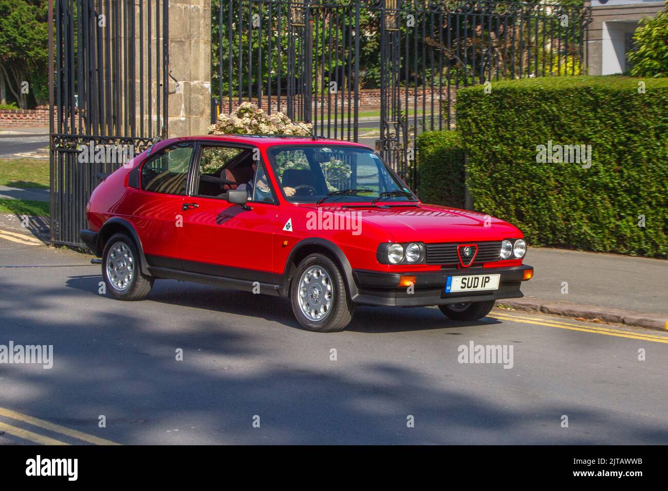 1983 80s eighties Red ALFA ROMEO 1490cc Petrol Italian sports car; Cars arriving at the annual Stanley Park Classic Car Show in the park gardens. Stanley Park classics yesteryear Motor Show Hosted By Blackpool Vintage Vehicle Preservation Group, UK. Stock Photo