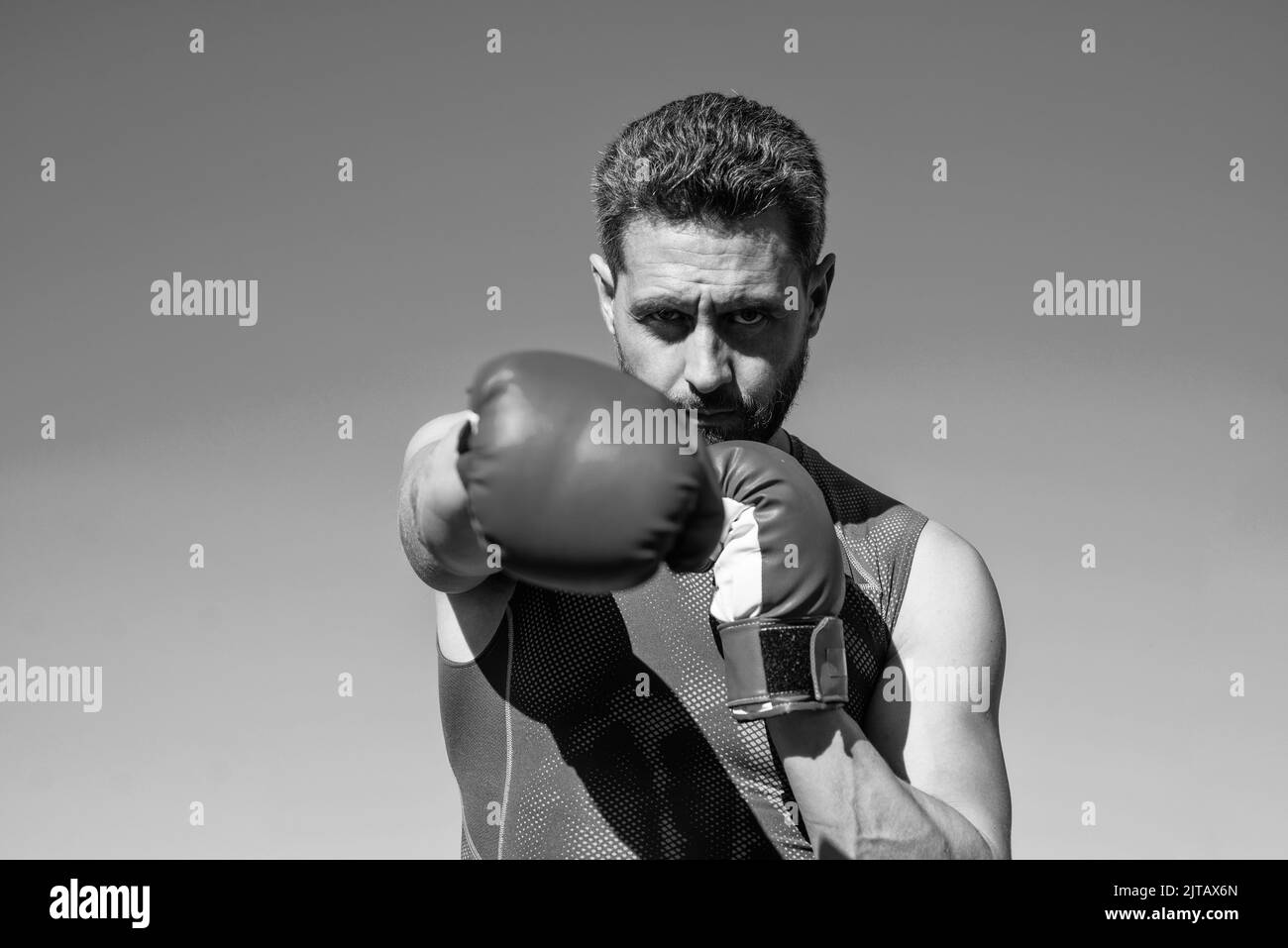 man boxer punching. fitness gym outdoor. muscular athletic guy training