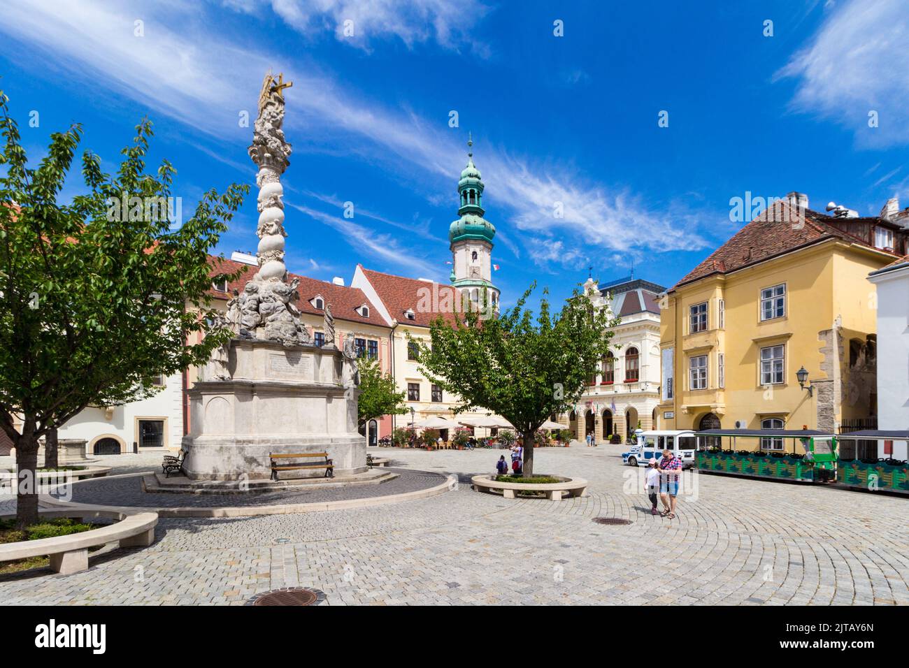 Fo ter (Main Square) with Holy Trinity Statue (1701), Firewatch Tower and tourist train, Sopron, Hungary Stock Photo