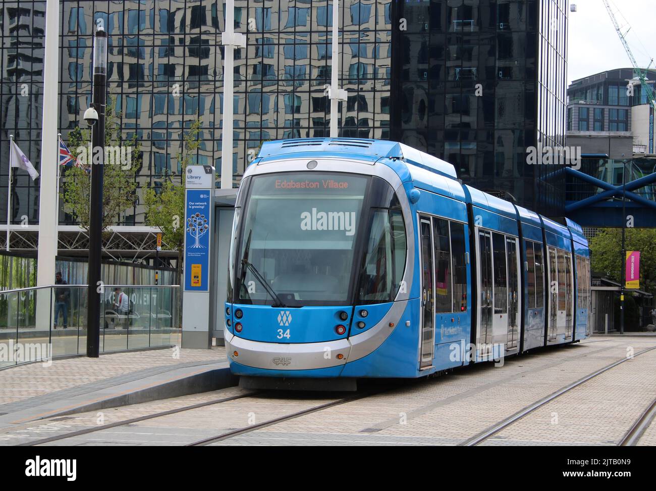 West Midlands Metro CAF Urbos 3 tram, number 34, at Library tram stop in Centenary Square, Birmingham on 18th August 2022. Stock Photo