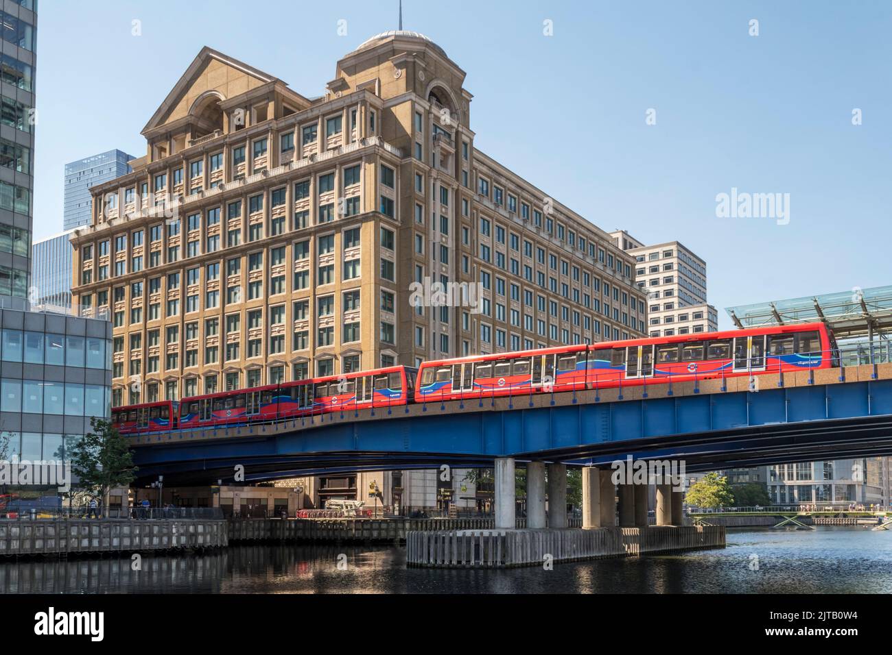 Fisherman's Walk and DLR train crossing part of West India Dock in London's old docklands. Stock Photo