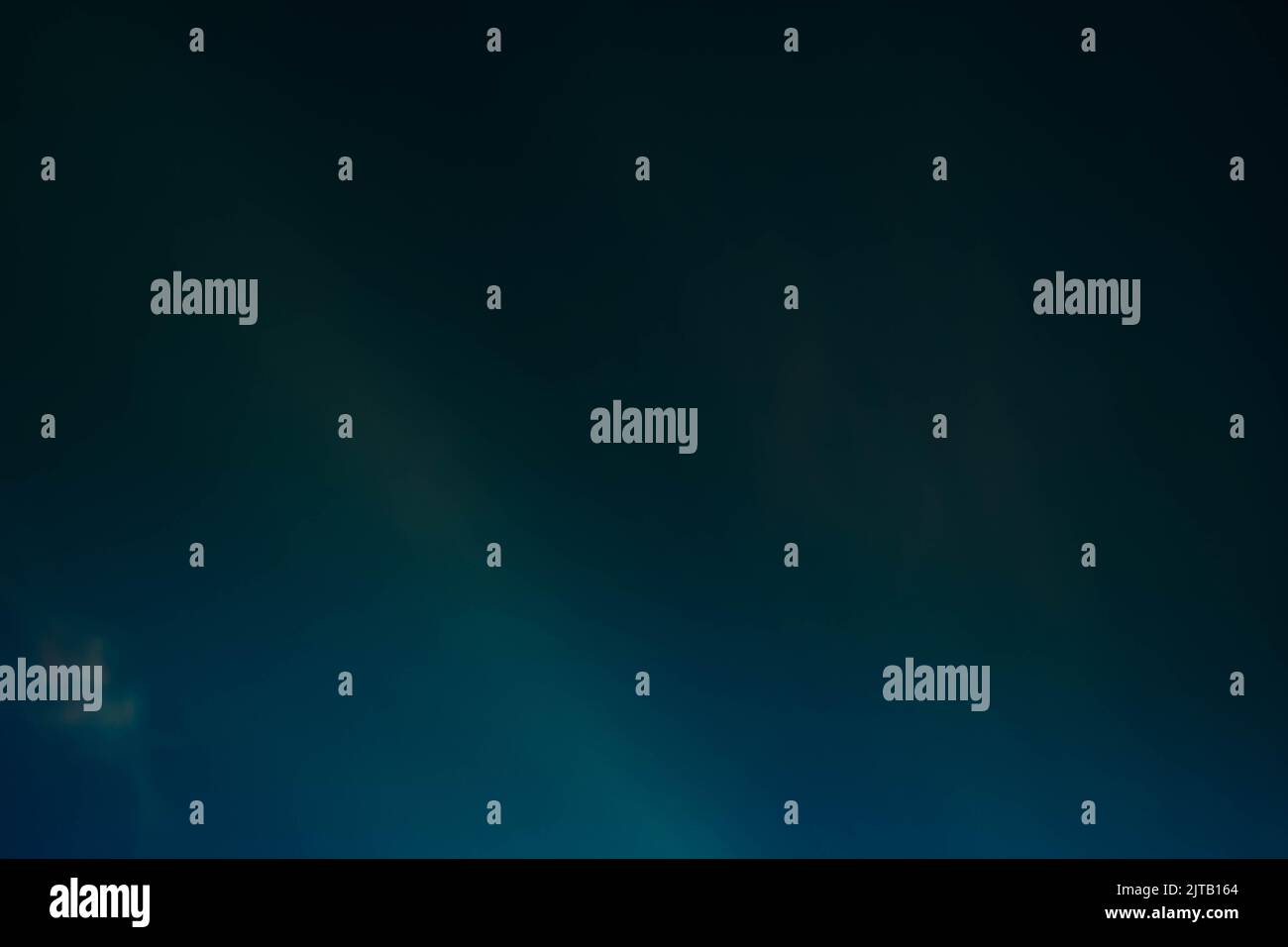 teal blue glow dark background lens flare light Stock Photo - Alamy