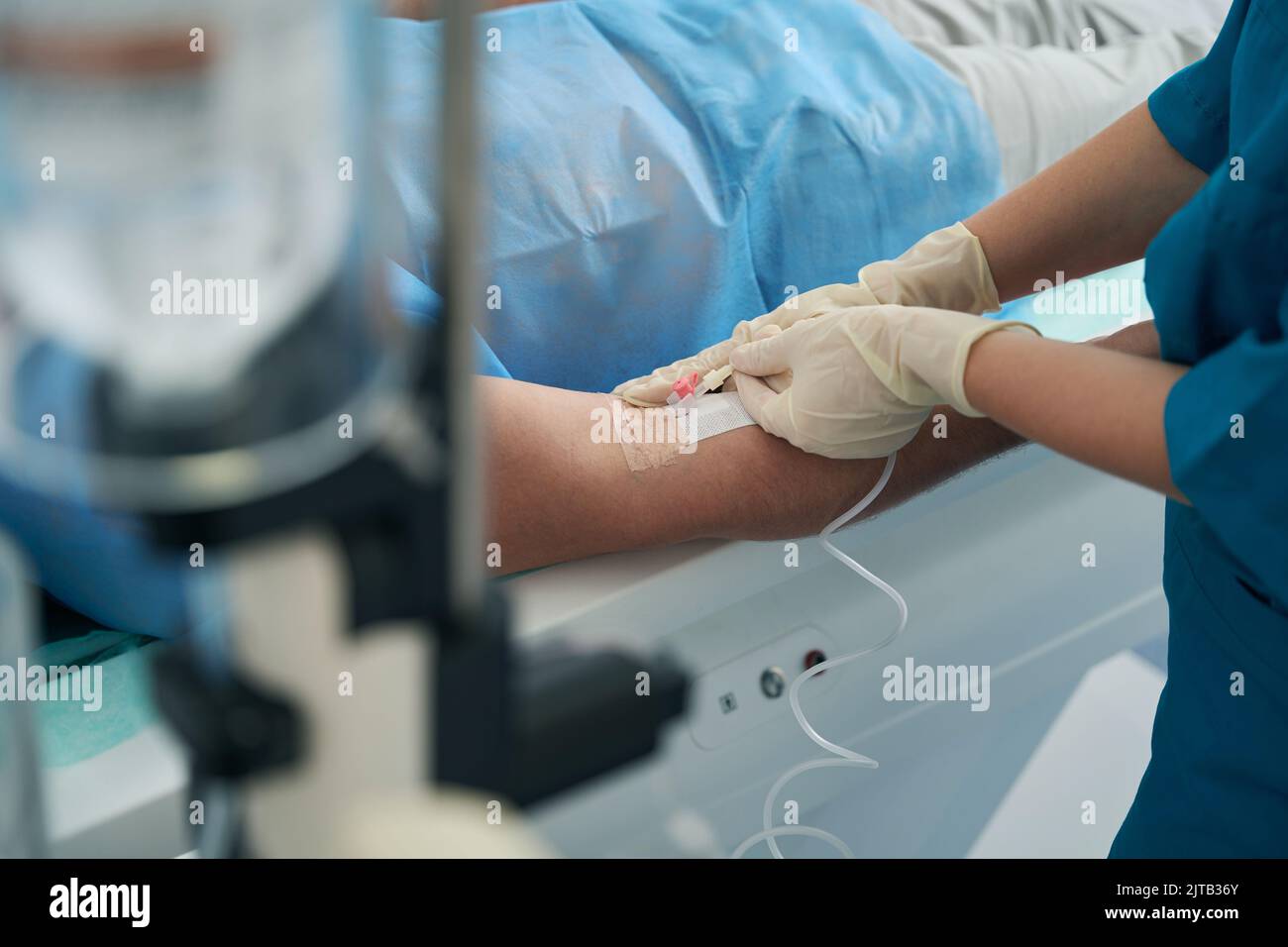 Patient in the hospital is put on a drip with medicine Stock Photo Alamy