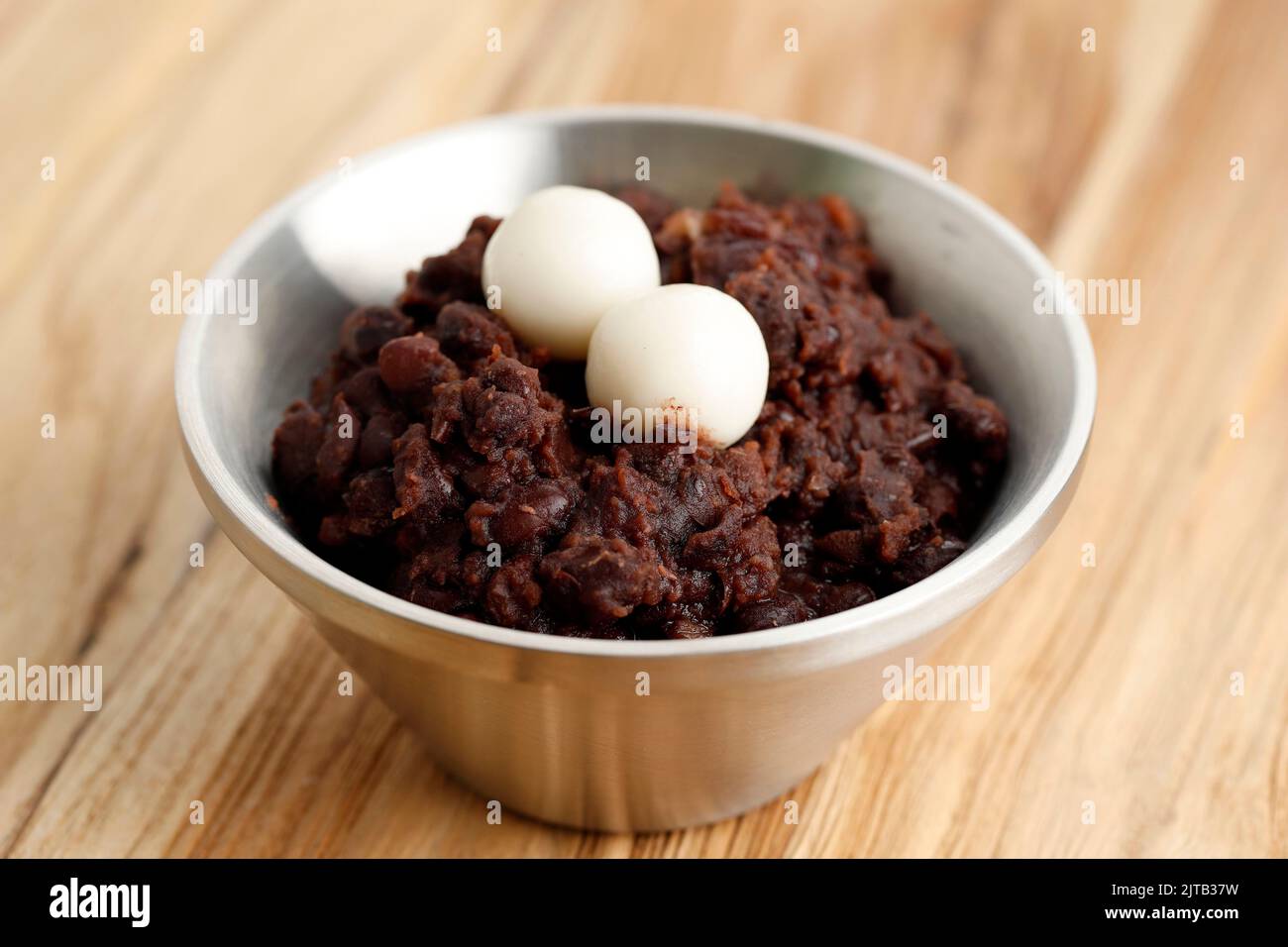 Korean Red Bean Porridge with Rice Cake Topping or Patjuk. On Wooden Table Stock Photo